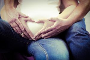 Women's health: pregnancy, birth preparation, pregnant woman with daddy