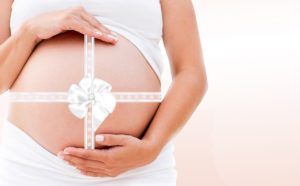 Women's health, post natal, c-section, pregnant woman with belly/baby gift