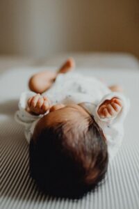 Newborn checkup babie on his back from the top