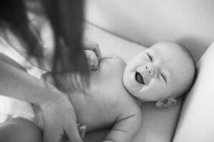 Benefits of Infant/Baby Massage. Baby smiling while massaged